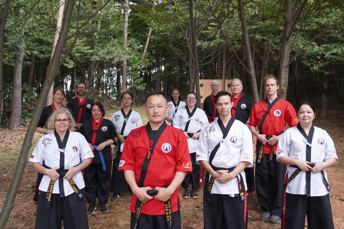 Weapons training with sword and staff outdoors